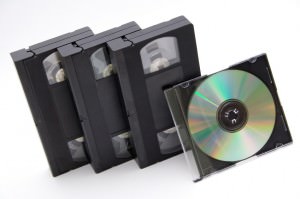 VHS cassettes and CD disc on white background